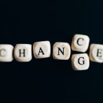 Letter dice forming the word 'Change' on a dark background, symbolizing transformation and opportunity.