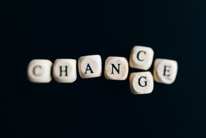 Letter dice forming the word 'Change' on a dark background, symbolizing transformation and opportunity.