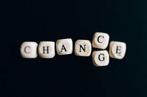 Letter dice forming the word 'Change' on a dark background, symbolizing transformation and opportunity.